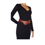 Woman wearing a black dress with a wide red-brown belt 